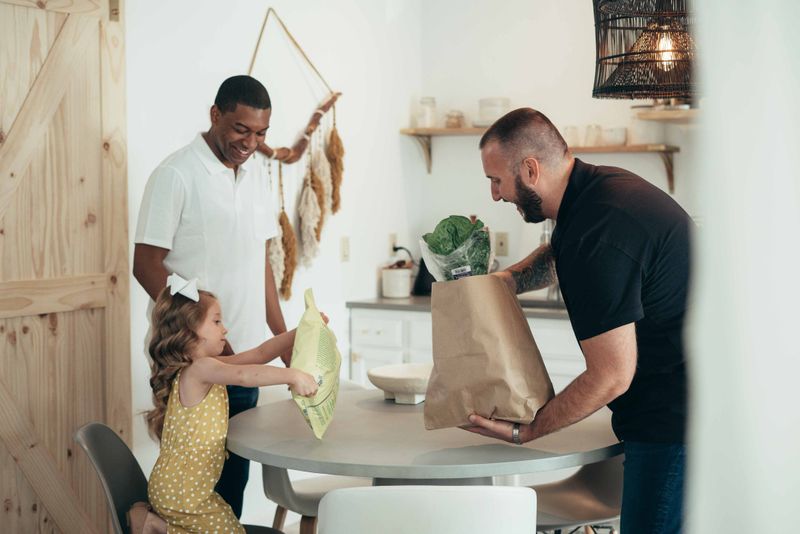 Un parent et son enfant rangent leurs courses à la cuisine